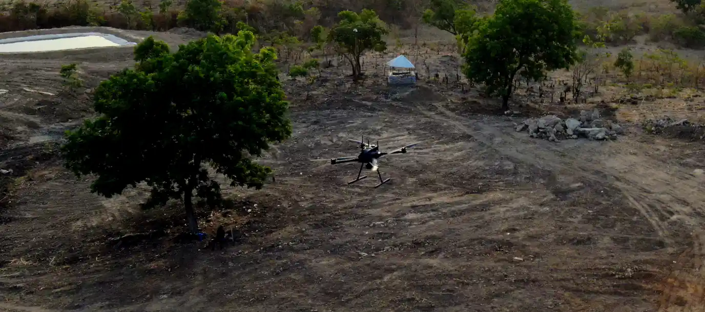 Terra Industries Iroko drone in flight over a cleared mining site