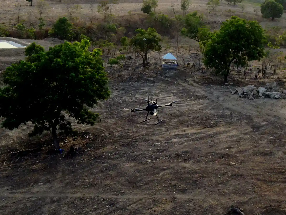Terra Industries Iroko drone in flight over a cleared mining site